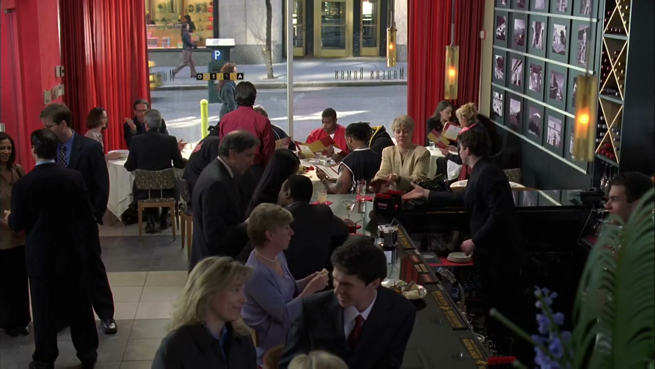 [Restaurant patrons murmuring]
