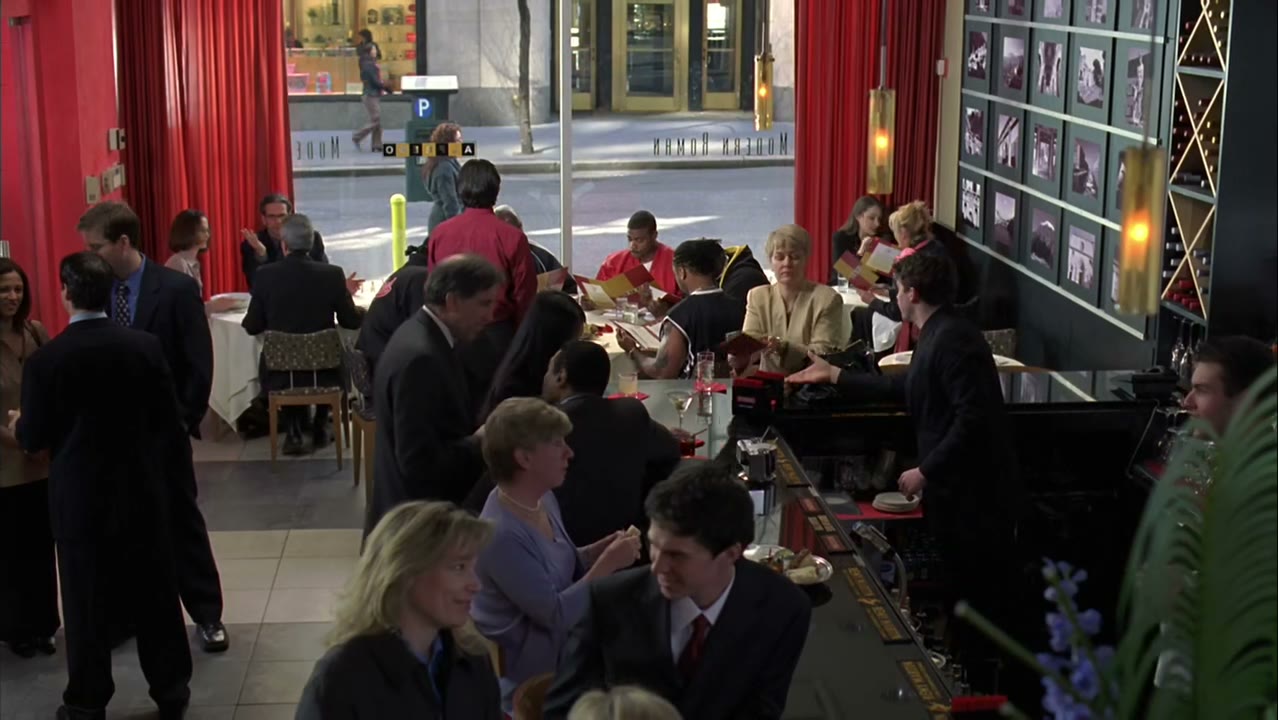 [Restaurant patrons murmuring]