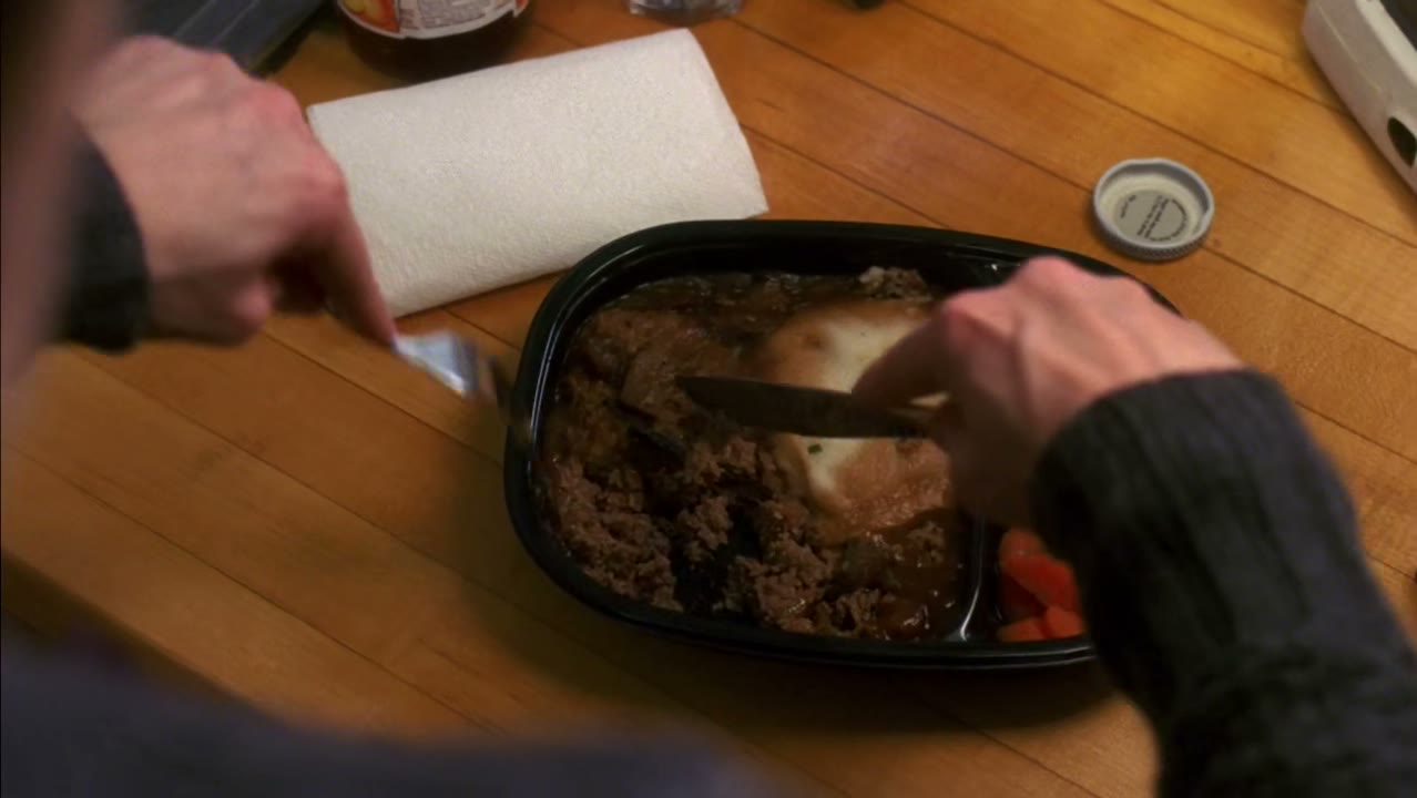 [TV playing in background]