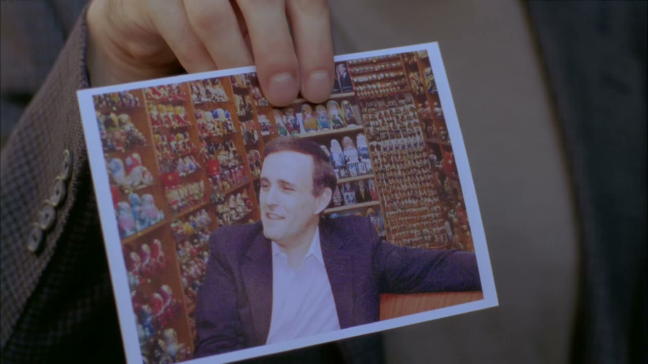 With his collection of antique wooden dolls.