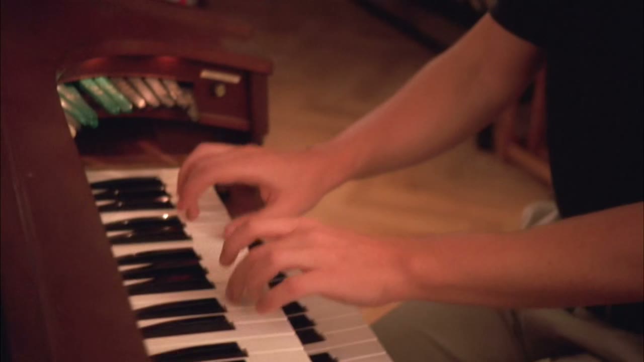 [Playing organ]