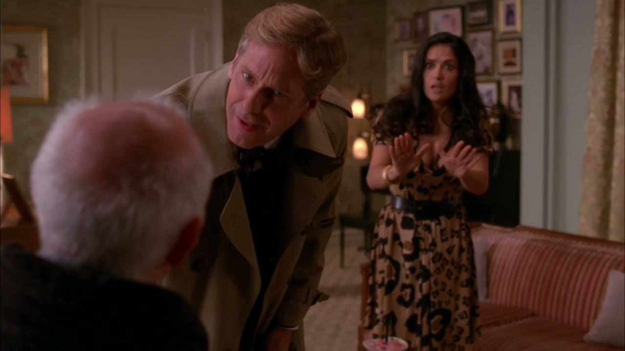 He wears a suit. His hair is thick...