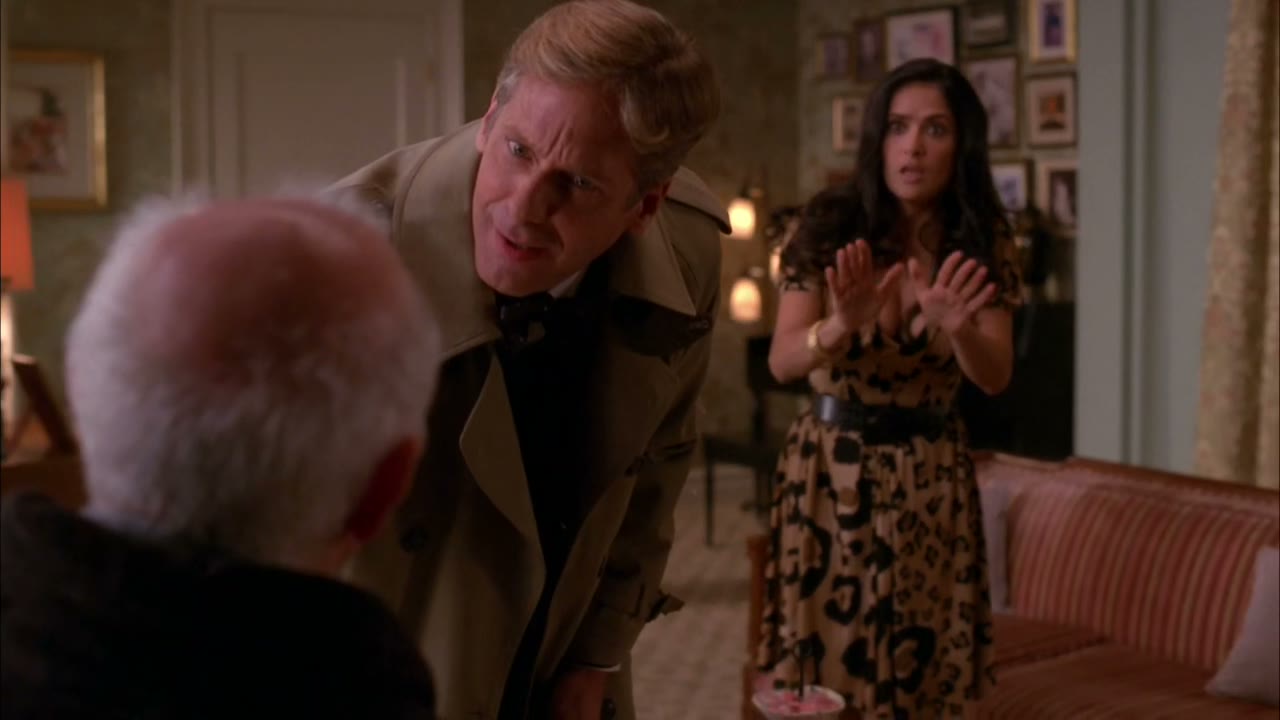 He wears a suit. His hair is thick...