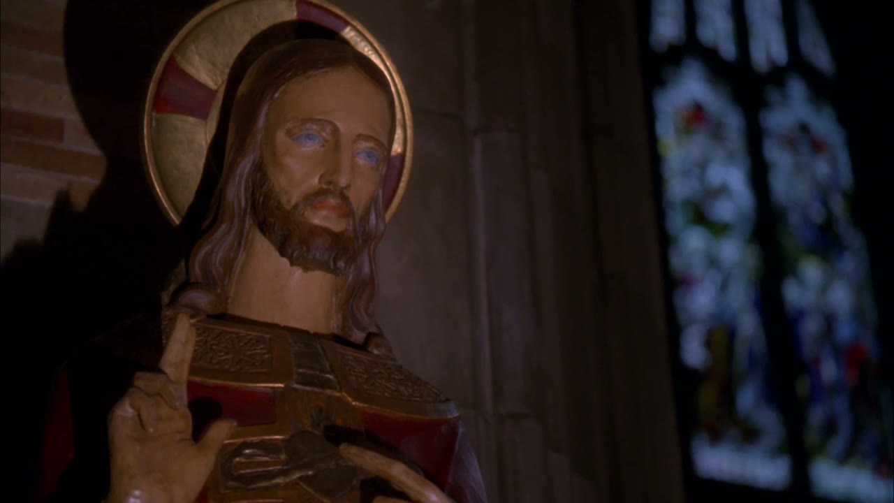[Priest chanting in Latin]