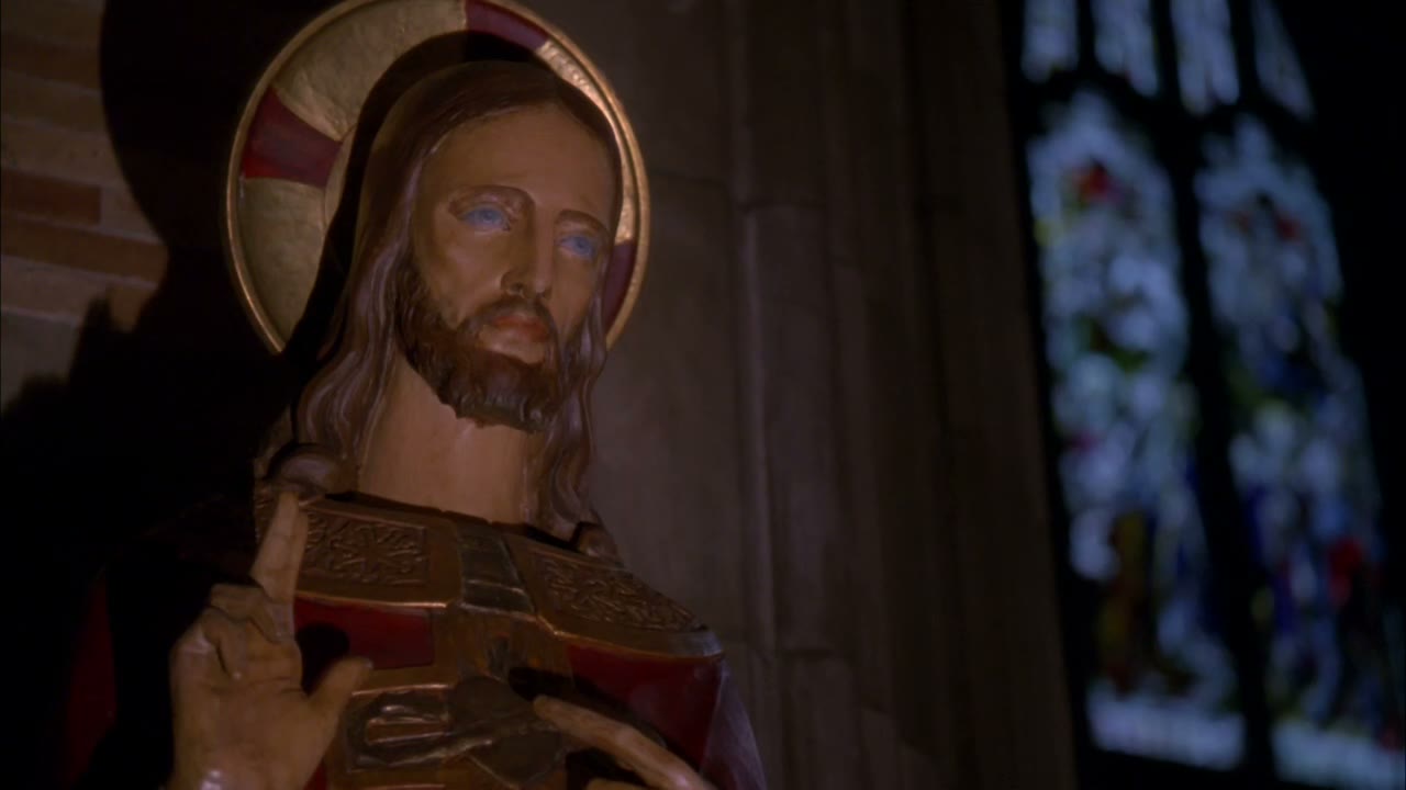 [Priest chanting in Latin]